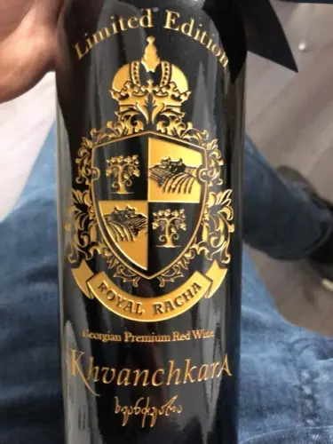 A bottle of Limited Edition Royal Racha Georgian Premium Red Wine with gold detailing.
