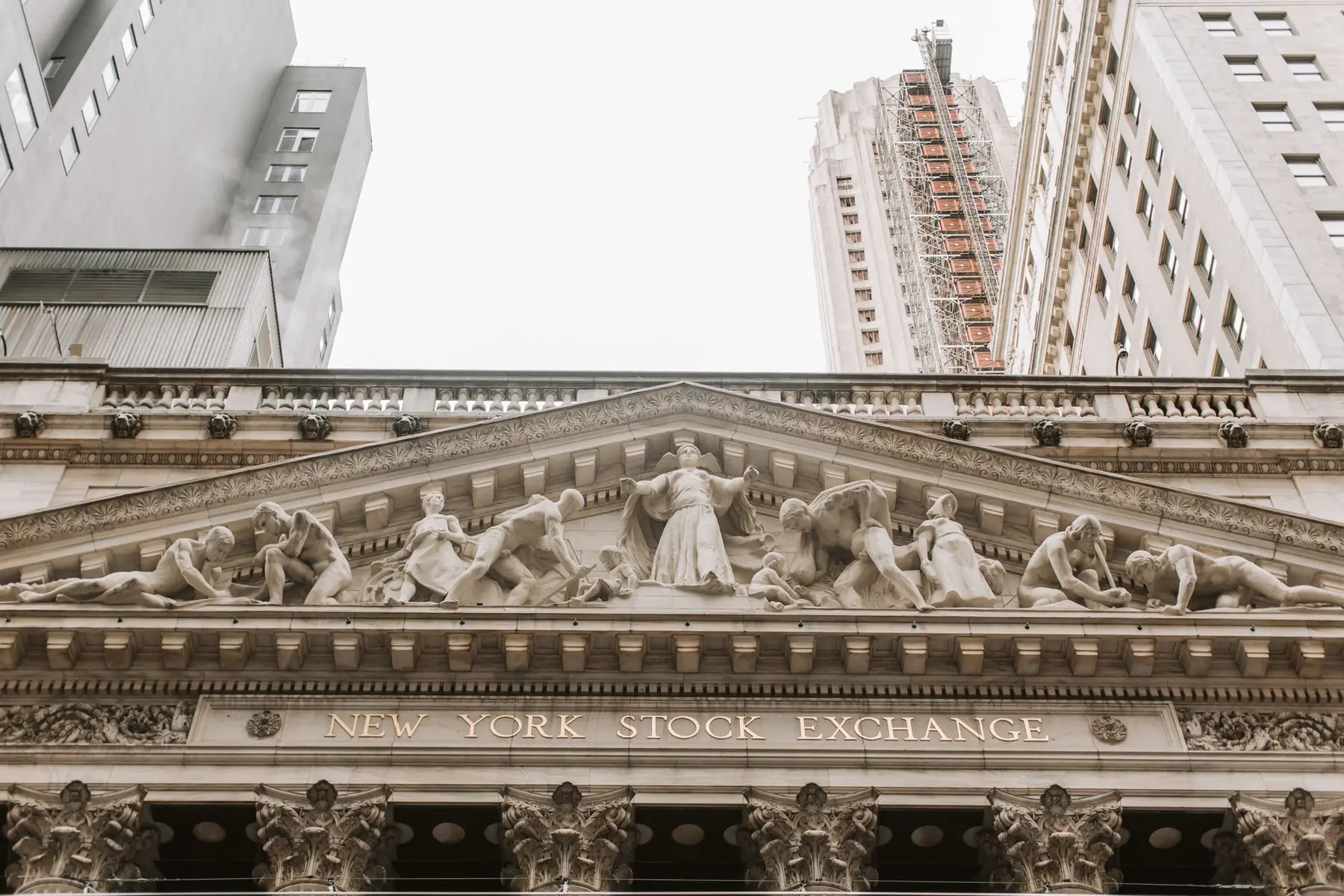 Detailed view of the neoclassical facade and pediment sculptures of the New York Stock Exchange