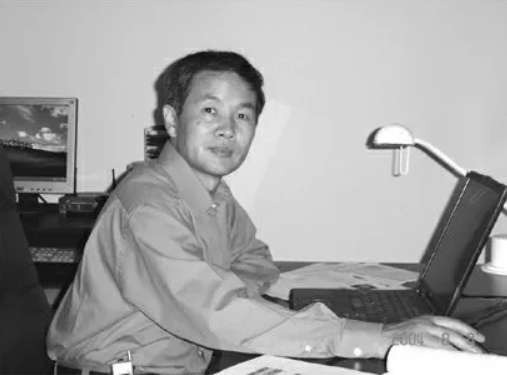wei dai, the potential creator of bitcoin, using a laptop in his office