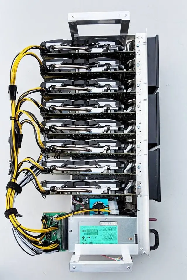 Top view of a Bitcoin mining rig featuring multiple GPUs and power supply connections.