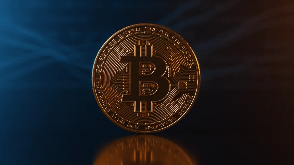 Bitcoin coin with dramatic lighting representing long-term holder accumulation and market bottom formation