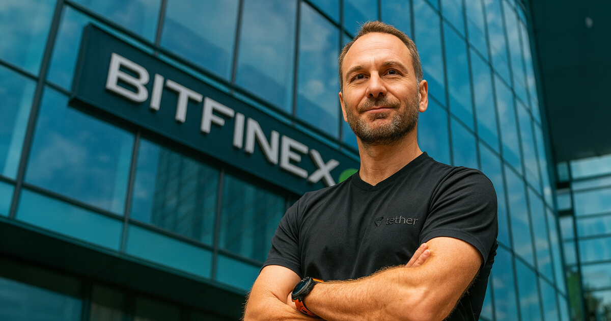 Paolo Ardoino stands confidently with arms crossed in front of the Bitfinex headquarters, wearing a black Tether shirt, reflecting his role in a crypto-focused interview about Bitcoin and Ethereum options markets.